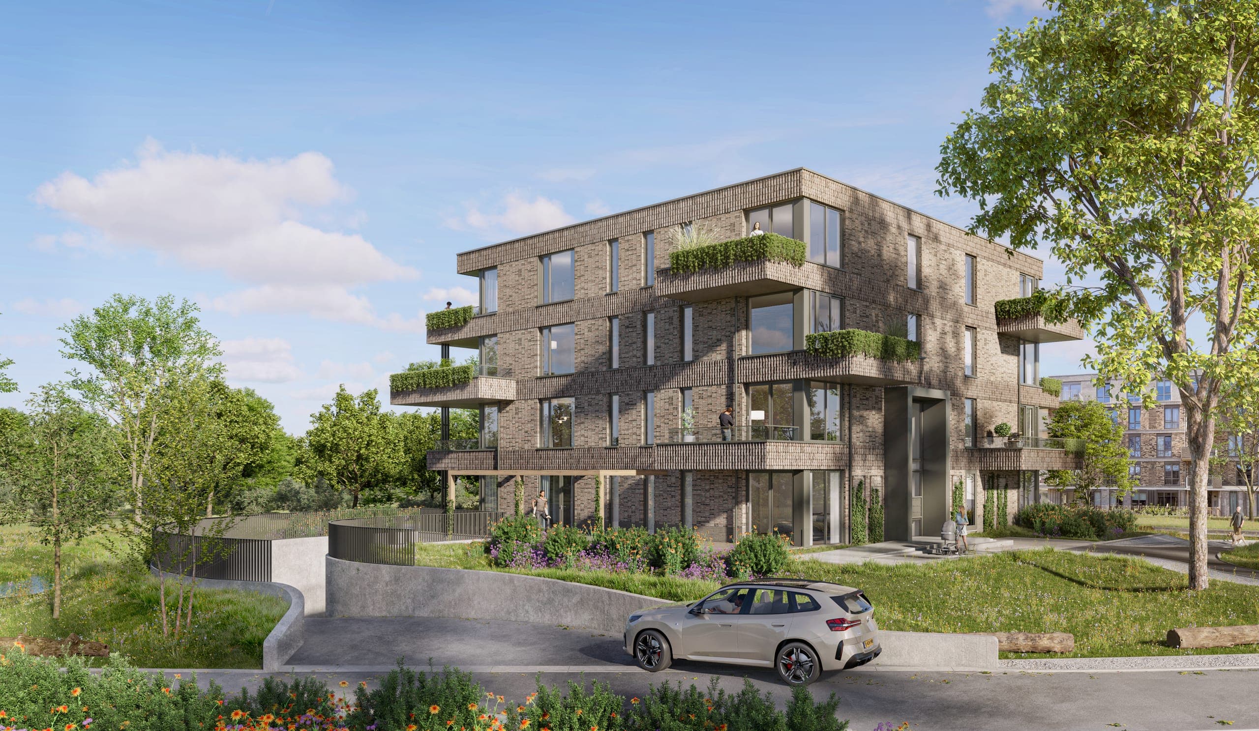 Het appartementencomplex gezien vanaf het groen, met een boom op de voorgrond